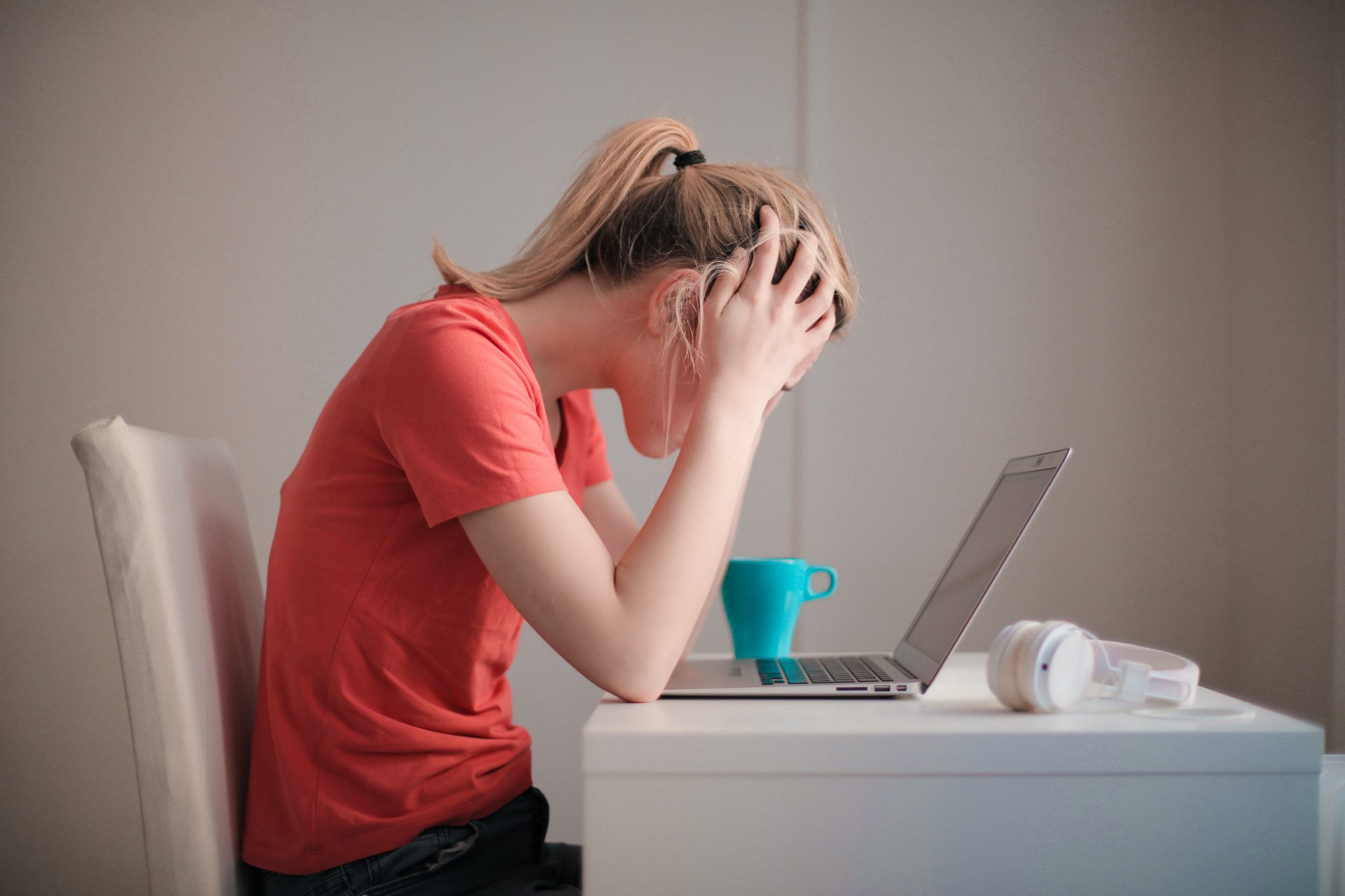 woman-in-red-t-shirt-looking-at-her-laptop-3755761-scaled-1